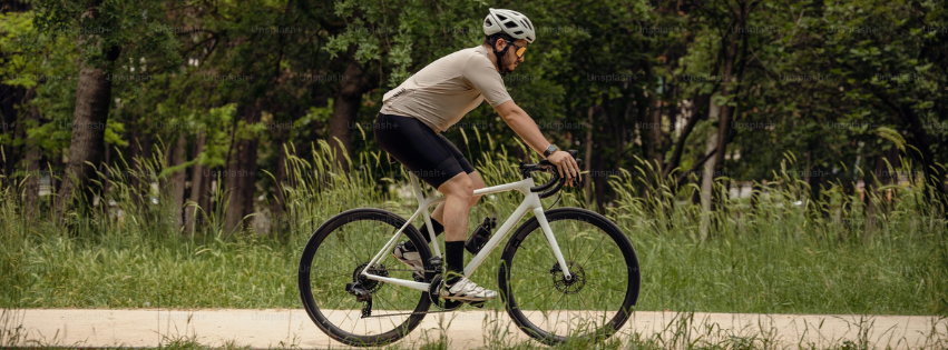 A Man is riding a white Men Bicycle